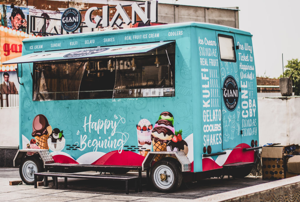 blue and pink ice cream food trailer parked in an urban area